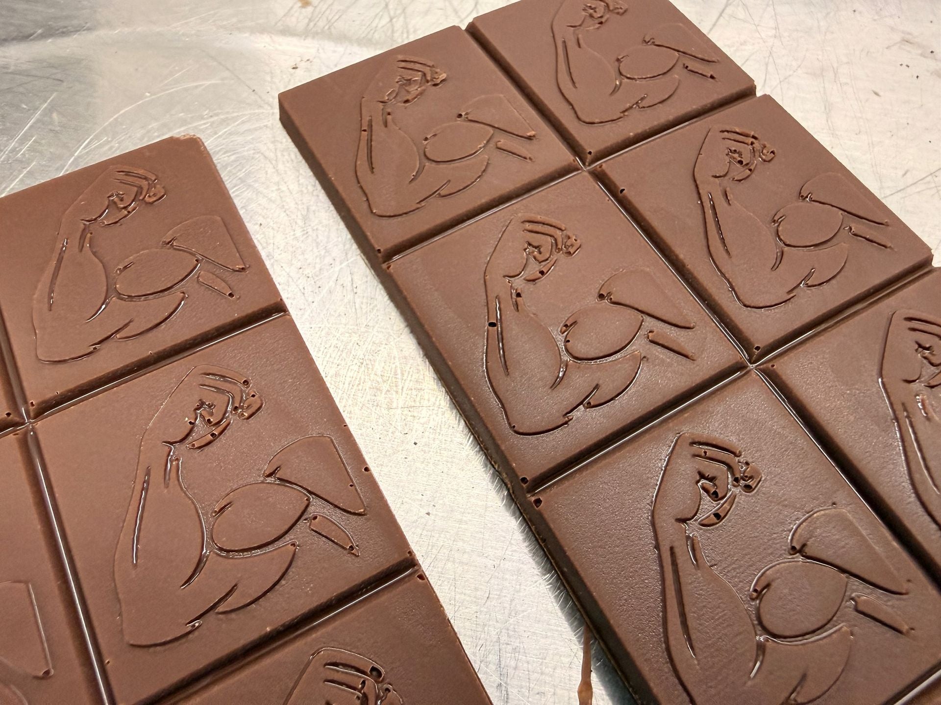 Swole Bar Max Milk milk chocolate bars with embossed flexed-arm squares